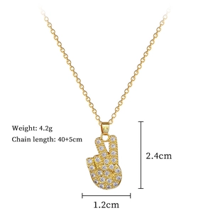 Macro shot showing gold titanium necklace dimensions 40cm and 2.4cm victory hand pendant