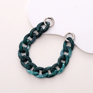 Detail shot of a dark green marble acrylic chain strap with silver metal ring buckles