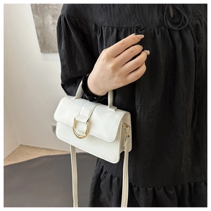 Close-up of white PU leather handbag featuring a U-shaped gold hardware buckle and strap