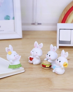 Set of four cute resin rabbit figurines in various playful poses for desk decoration