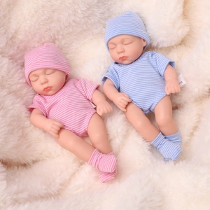 Realistic 20cm reborn baby dolls in pink and blue striped outfits on soft white fur
