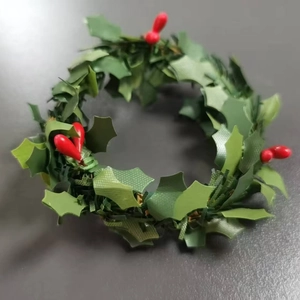 Handcrafted Christmas napkin ring with green holly leaves and red berries for table decor