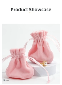Detail of pink velvet drawstring jewelry pouches on display with pearl ring accessory