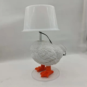 Close-up of a creative white resin chicken night light with detailed feather textures
