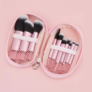 Detail of pink makeup brush set with 8 brushes and matching zipper storage mesh bag