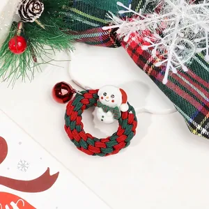 Detailed shot of Christmas velvet hair scrunchie with snowman charm and a red bell