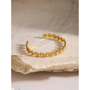 18k gold-plated stainless steel daisy bangle with pearls on light natural stone