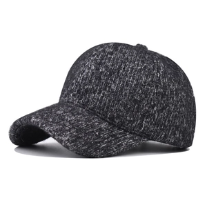 Detail view of the thick dark grey knitted fabric and fleece lining on the winter baseball cap