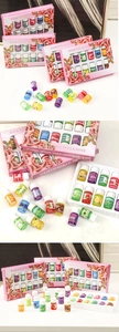 Macro view of water-soluble essential oils set in 12 assorted floral and fruit scents