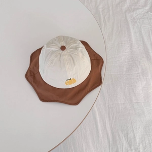 Macro detail of breathable petal-brim sun hat with fruit embroidery for kids