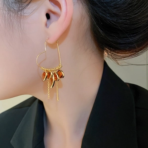 Detail shot of 18K gold plated heart earrings with brown crystal and elegant long tassels