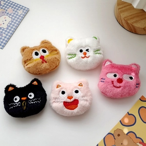 Detailed macro view of five colorful plush cat brooches with embroidered facial expressions