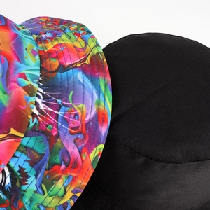 Close-up of double-sided bucket hat featuring colorful abstract print and solid black fabric