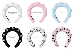 Detail view of colorful terry cloth and flannel headbands with white pearl embellishments