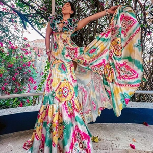 Detail of vibrant tie-dye two-piece set with ruffled crop top and high-waist maxi skirt