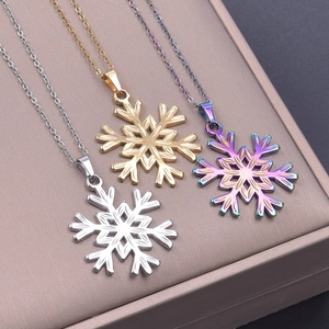 Detailed view of snowflake pendant necklaces in silver, gold, and rainbow finishes