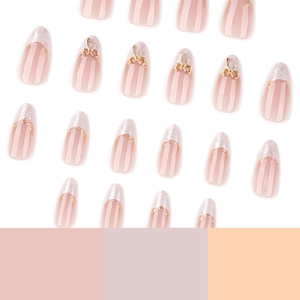 Short almond press-on nails with white marble design and gold 3D bow accents