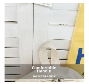 Detailed view of the widened woven handle and sturdy dual metal zippers on children backpack