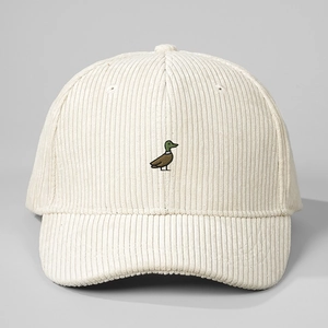 Close-up of duck embroidery on beige corduroy fabric with detailed striped texture