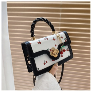 Cute white cherry print square handbag with black twist handle and gold flower clasp