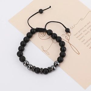 Detail of luxury men's bracelet with matte black beads and rhinestone crown charms
