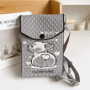 Detail of grey knitted phone bag with cute cartoon animal motif and woven textures