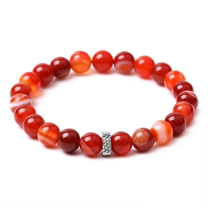 Close-up of natural red agate bead bracelet with a textured silver metal spacer bead