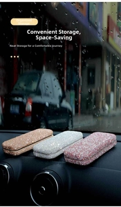 Close-up of diamond-studded car eyeglass holders in gold, silver, and red finishes
