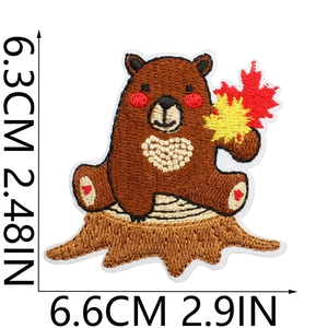 Detail of bear embroidery patch with dimensions 6.3x6.6cm on a white background