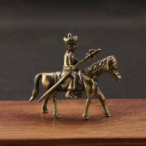 Detail of copper-plated Tang Monk figure on a horse with intricate vintage engraving details