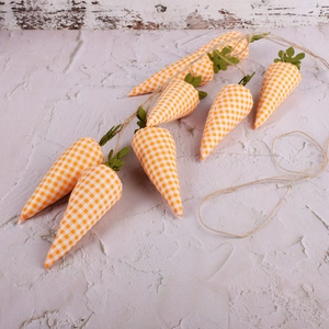 Detail of fabric carrot banner with orange plaid pattern and green leaves for Easter decor