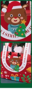 Close-up of red Christmas gift box with cartoon reindeer and Merry Christmas text