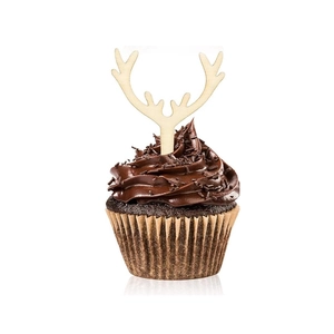 Detail view of a wooden reindeer antler topper on a chocolate cupcake for Christmas