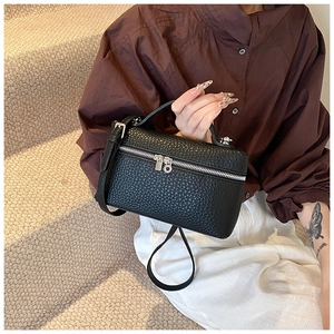 Detail of black litchi grain vanity case bag with silver dual zippers and top handle