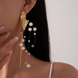 Vintage floral pearl tassel earrings with golden leaf design and zircon accents on model