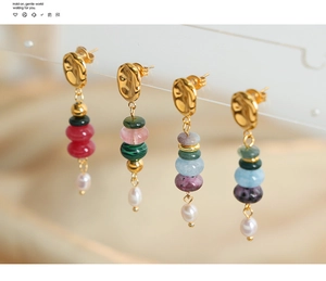 Detail of handmade drop earrings with natural stones, gold hammer finish, and teardrop pearls