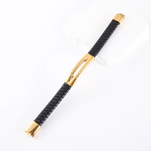 Detailed macro view of black braided leather strap with gold stainless steel clasp elements