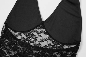 Close-up of black lace patchwork and fine floral details on this halter backless dress
