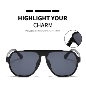 Detail view of large frame sunglasses featuring metal hinge reinforcement and matte black finish