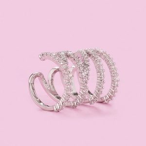 Detailed close-up of four-layer silver ear cuff with sparkling zircon stone pavé setting