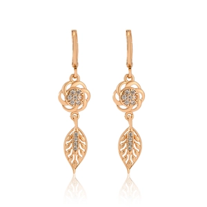 Detailed view of rose gold floral earrings with hollow leaves and inlaid cubic zirconia
