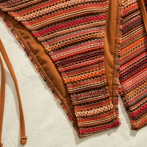 Macro shot of multi-color striped crochet bikini fabric with detailed knit texture