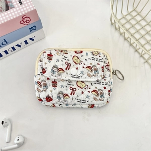 Detail of quilted mini pouch featuring cute cartoon cat prints and metal keychain ring