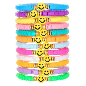 Stack of 12 colorful bohemian rainbow clay bead elastic bracelets with gold accent beads