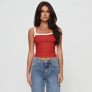 Detail of red slim-fit camisole with delicate white lace trim on the neckline