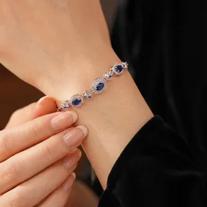 Elegant vintage oval sapphire blue halo bracelet with silver plating and sparkling crystals