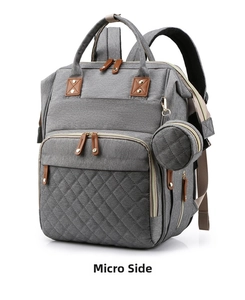 Detail view of light grey diaper bag with diamond quilting and round coin purse pouch