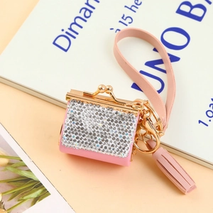 Pink rhinestone encrusted mini coin purse keychain with gold hardware and tassel charm