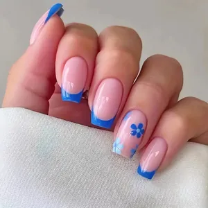 Close-up of square press-on nails with blue French tips and delicate floral hand-painted art