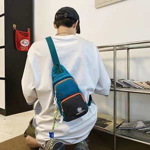 Water-resistant street style chest bag in lake blue and checkered pattern shown on model